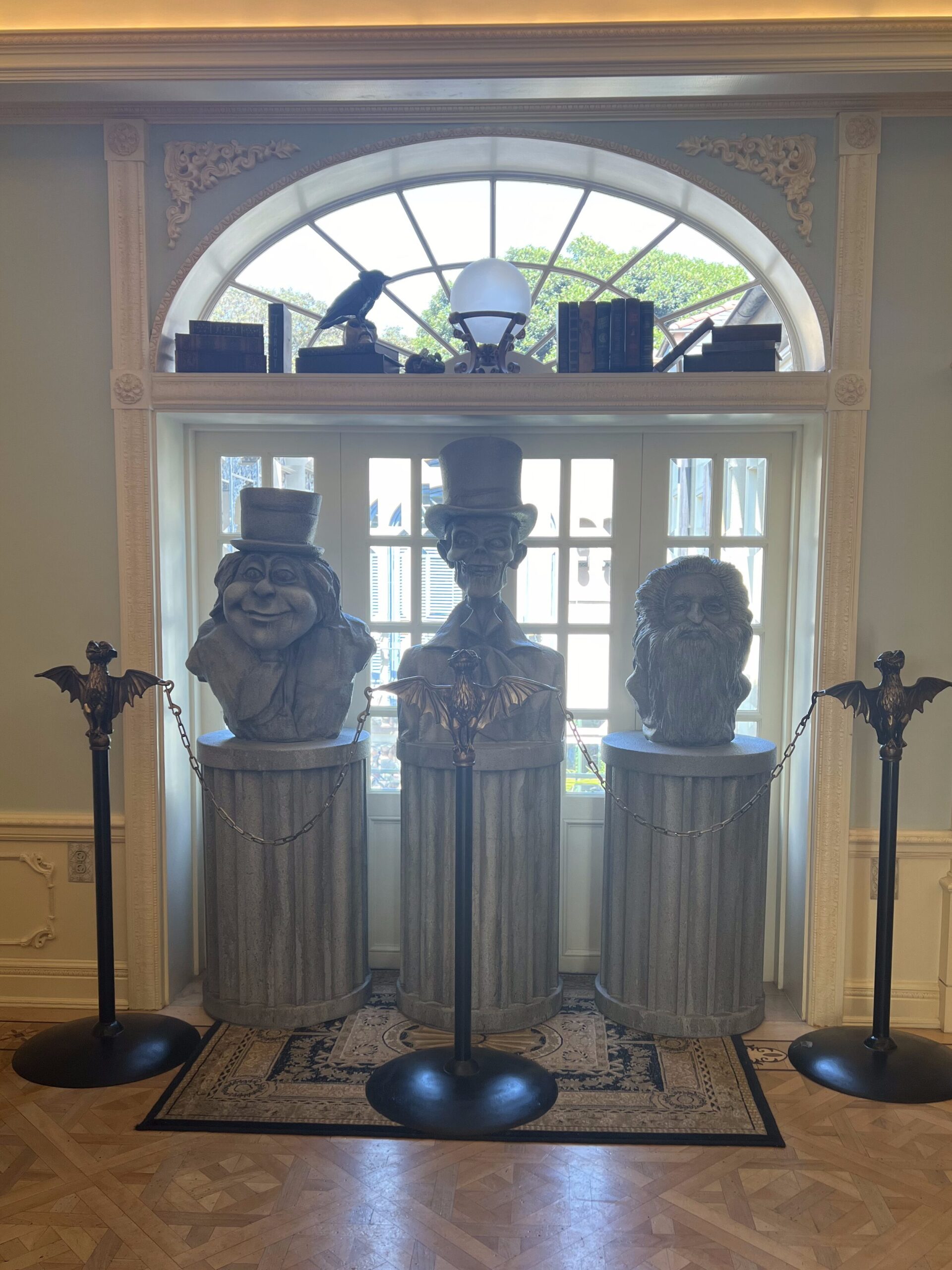 Busts of the Hitchhiking ghosts from the Haunted Mansion in the entry way of Club 33. 